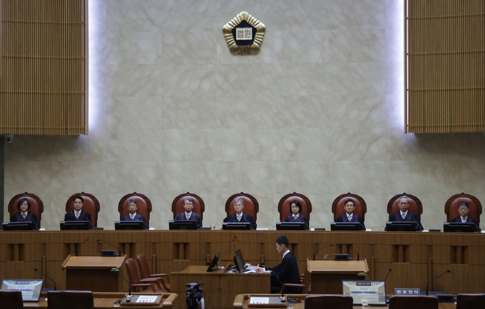South Korea's Supreme Court Chief Justice Cho Hee-dae, center, and other justices are seated in the courtroom to attend a hearing to hand down a ruling on the election law violation case of the Democratic Party presidential candidate Lee Jae-myung in Seoul, South Korea, Thursday, May 1, 2025. (Yonhap via AP)