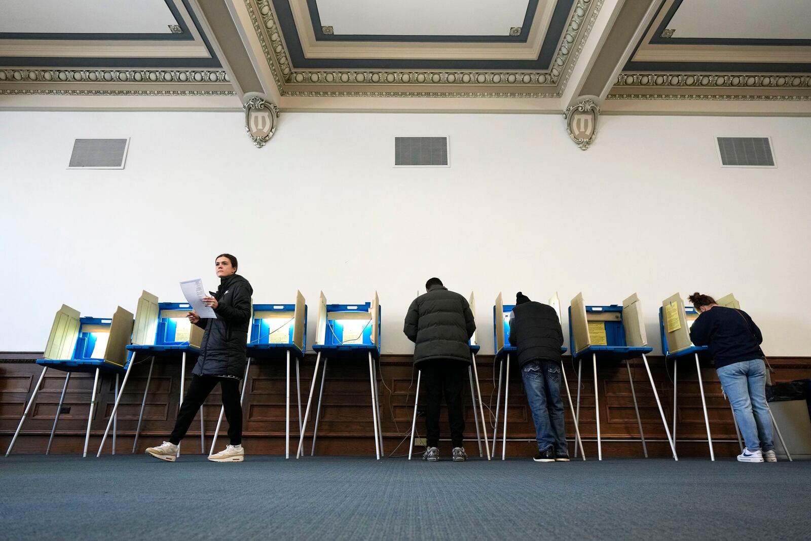 Voters mark their ballots while voting at Centennial Hall at the Milwaukee Central Library on Election Day Tuesday, April 1, 2025, in Milwaukee. (AP Photo/Kayla Wolf)