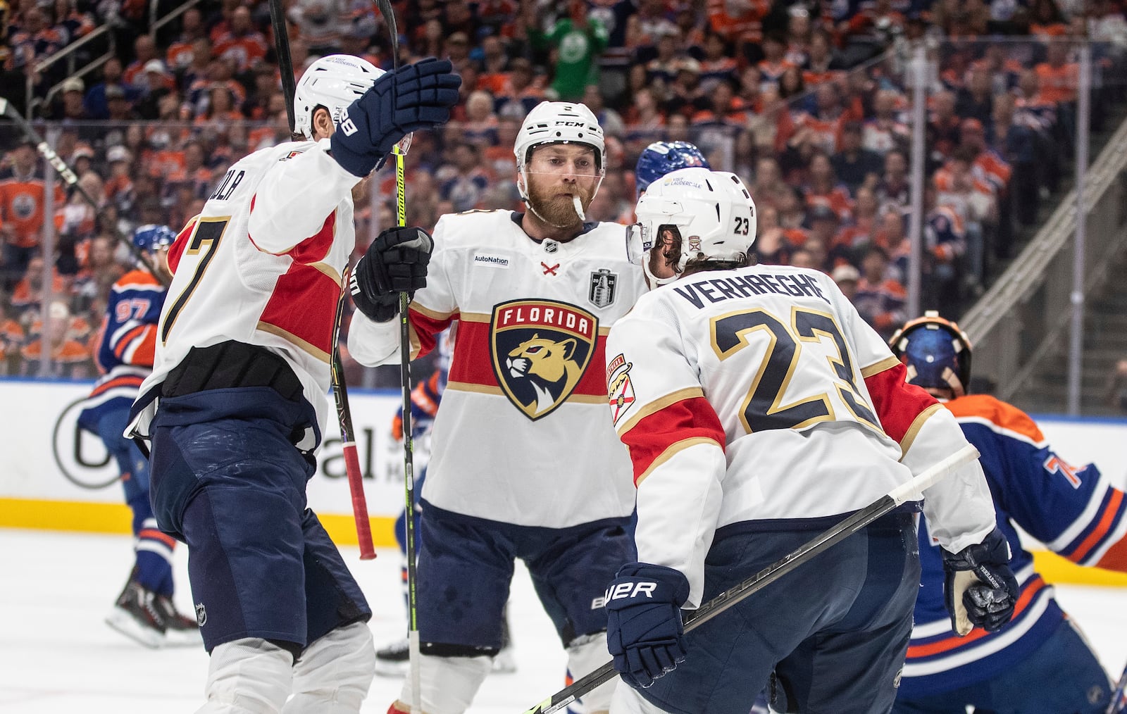 Florida Panthers' Dmitry Kulikov (7), Sam Bennett (9) and Carter Verhaeghe (23) celebrate a goal against the Edmonton Oilers during the first period in Game 1 of the NHL Stanley Cup final in Edmonton, Wednesday, June 4, 2025. (Jason Franson/The Canadian Press via AP)