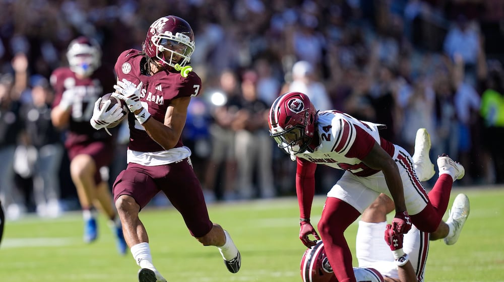 Texas A&M wide receiver Ashton Bethel-Roman (3) looks back at South Carolina defensive back Jalon Kilgore (24) after catching a pass for a first down during the second half of an NCAA college football game Saturday, Nov. 15, 2025, in College Station, Texas. (AP Photo/David J. Phillip)