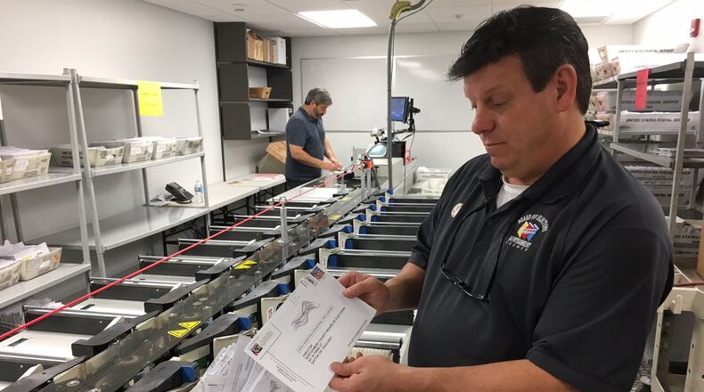 Sometimes absentee ballots arrive without the proper information or a signature. Those are separated out and voters are notified via mail and given a chance to correct the information so their vote can be counted.  In this file photo from 2016 Montgomery County Board of Elections Deputy Director Steve Harsman sorts through problem ballots. LYNN HULSEY/staff