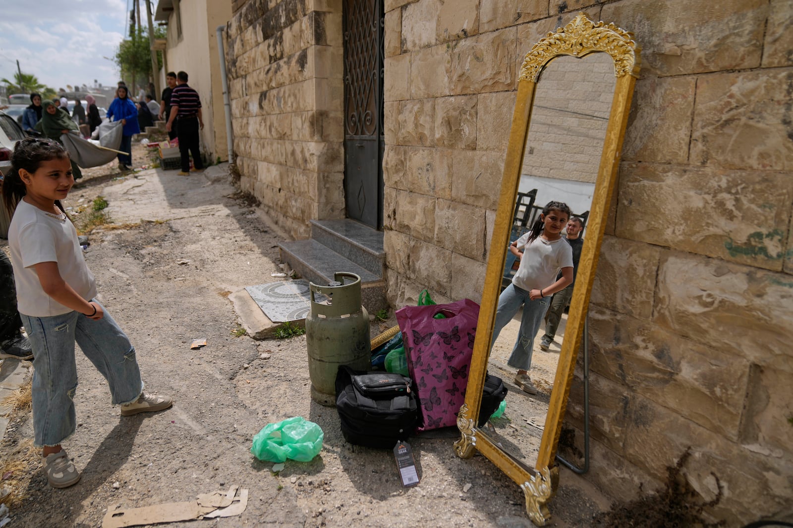 Residents of the now evacuated refugee camp of Tulkarem return to collect belongings before the destruction of their homes as Israeli forces prepare to carry out the demolition of 116 homes across the two refugee camps of the Israeli occupied West Bank city of Tulkarem, Friday, May 2, 2025. (AP Photo/Nasser Nasser)