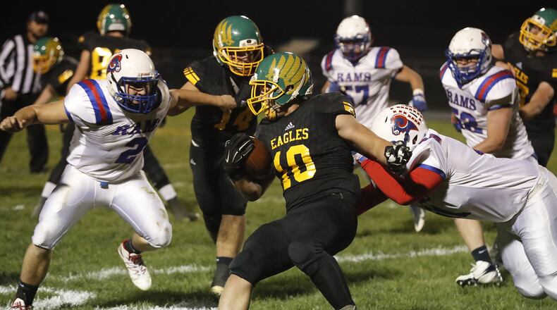 Madison-Plains’ Jacob Toops gets tackled by Greeneview’s Jacob Green, left, and Bryce Da. BILL LACKEY / STAFF