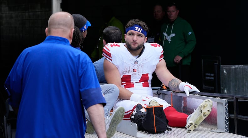 New York Giants running back Cam Skattebo (44) leaves the field after an injury during the first half of an NFL football game against the Philadelphia Eagles on Sunday, Oct. 26, 2025, in Philadelphia. (AP Photo/Chris Szagola)