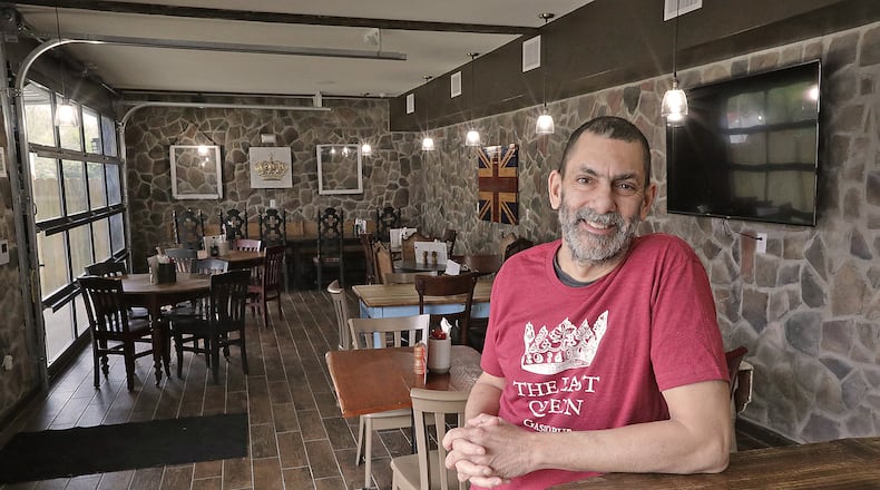 Adrian Shergill, the owner of The Last Queen gastropub, has created the look and feeling of a British pub in Enon. From the food to the decor and even the smell of fish-n-chips cooking transports customers across the sea. BILL LACKEY/STAFF