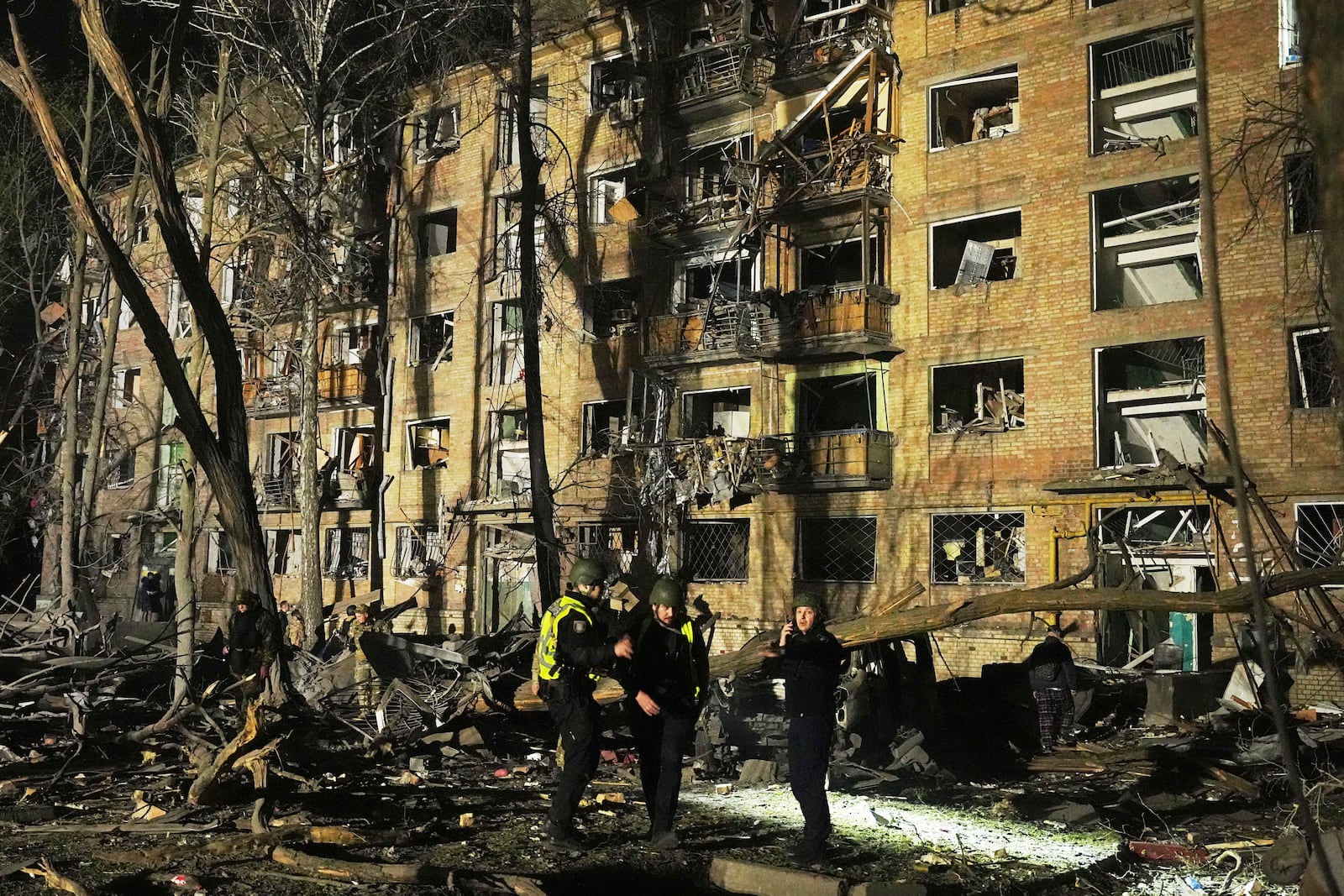 Ukrainian police officers stand near a damaged building after a Russian ballistic missile attack in Kyiv, Ukraine, early Thursday, April 24, 2025. (AP Photo/Efrem Lukatsky)