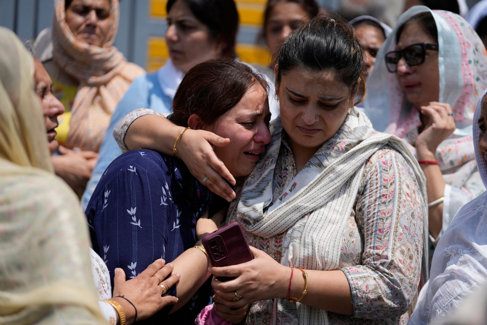 Relatives mourn at the funeral of Raj Thapa, a senior bureaucrat who was killed in Pakistani shelling in Rajouri, in Jammu, India, Sunday, May 11, 2025. (AP Photo/Channi Anand)