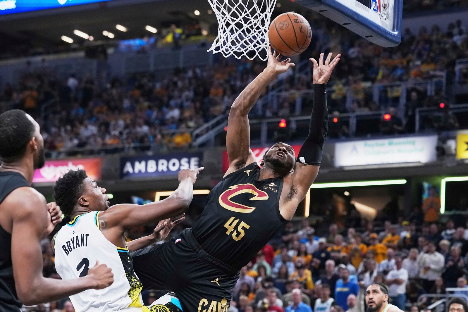 Cleveland Cavaliers guard Donovan Mitchell (45) shoots against Indiana Pacers center Thomas Bryant (3) in the first half of Game 4 in the Eastern Conference semifinals of the NBA basketball playoffs in Indianapolis, Sunday, May 11, 2025. (AP Photo/Michael Conroy)