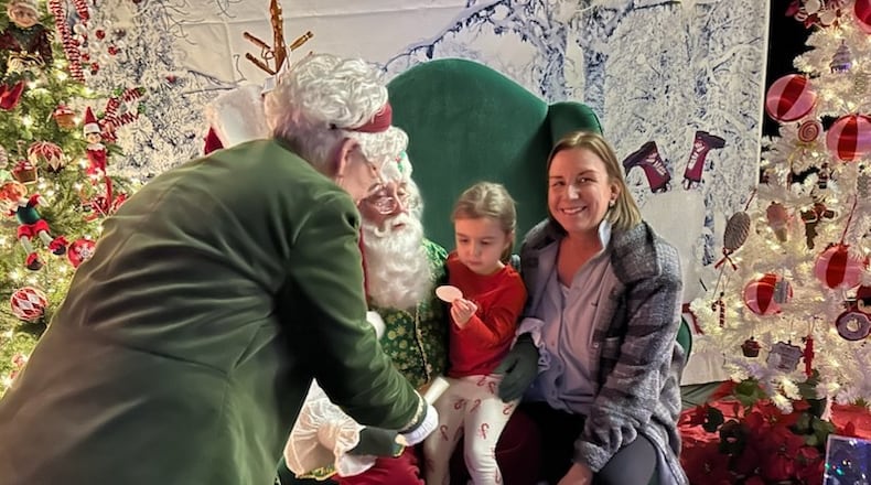 Melissa Heinzen and her daughter Lilly visited with Santa and Mrs. Claus at the Heritage Center of Clark County's Enchanted Forest during opening night activities for the 2025 Holiday in the City on Friday, Nov. 28. It will be one of the places Santa can be visited in the weeks leading up to Christmas.
BRETT TURNER/CONTRIBUTED PHOTO