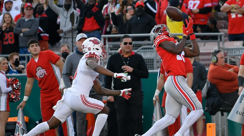Ohio State wide receiver Marvin Harrison Jr., right, catches a touchdown during the first half in the Rose Bowl NCAA college football game against Utah Saturday, Jan. 1, 2022, in Pasadena, Calif. (AP Photo/John McCoy)