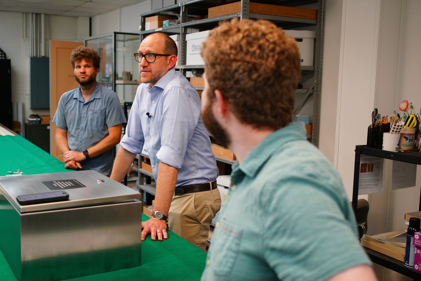 From left, Eric Schweickart, Jack Gary and Evan Bell chat in the Colonial Williamsburg archaeology lab in Williamsburg, Va., on Thursday, May 29, 2025. (AP Photo/Allen G. Breed)