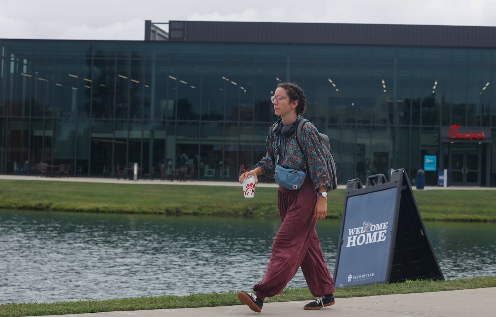 A student walks to class while drinking a Chick-fil-A milkshake during the first week at Cedarville University on Thursday, August 21, 2025, in Cedarville. JOSEPH COOKE/STAFF
