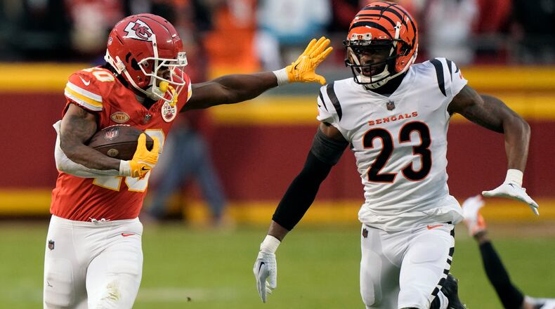 Kansas City Chiefs running back Isiah Pacheco runs for a first down as Cincinnati Bengals safety Dax Hill (23) defends during the first half of an NFL football game Sunday, Dec. 31, 2023, in Kansas City, Mo. (AP Photo/Charlie Riedel)