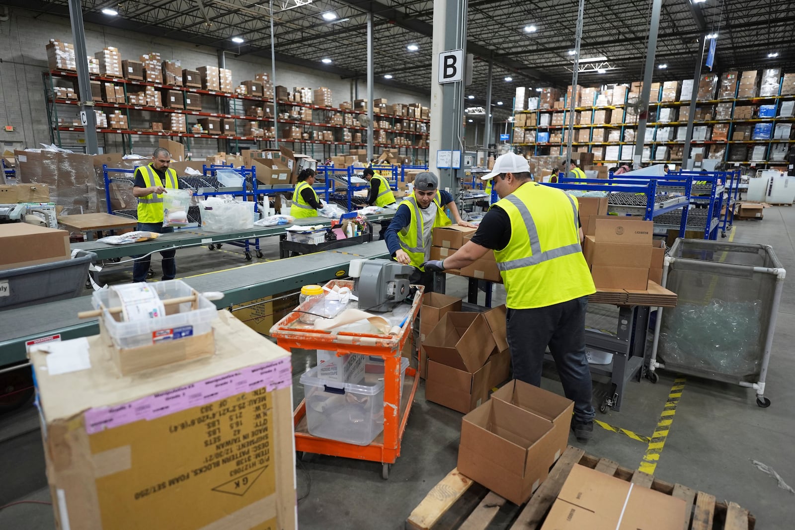 FILE - Employees of Learning Resources, an educational toy company, work at a warehouse in Vernon Hills, Ill., Friday, April 11, 2025. (AP Photo/Nam Y. Huh, File)