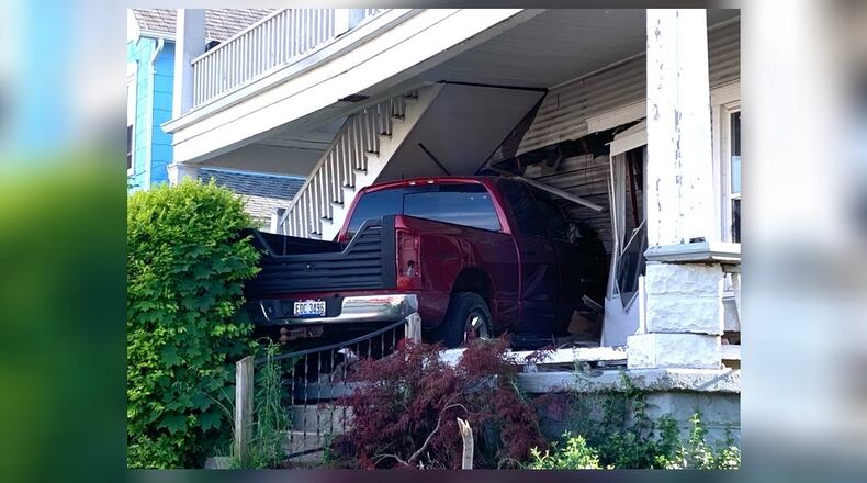A pickup truck drove up a set of steps before slamming into a duplex on North Isabella Street Wednesday evening, June 3, 2020, in Springfield. BILL LACKEY / STAFF