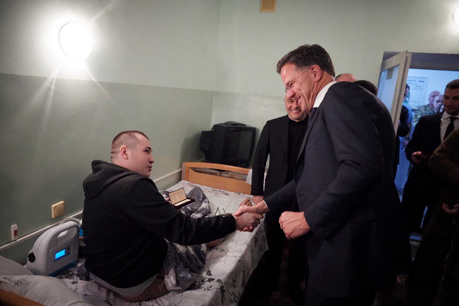 In this photo provided by the Ukrainian Presidential Press Office, NATO Secretary General Mark Rutte, shakes hands with a wounded Ukrainian soldier during his visit to a hospital in Odesa, Ukraine, Tuesday, April 15, 2025.(Ukrainian Presidential Press Office via AP)