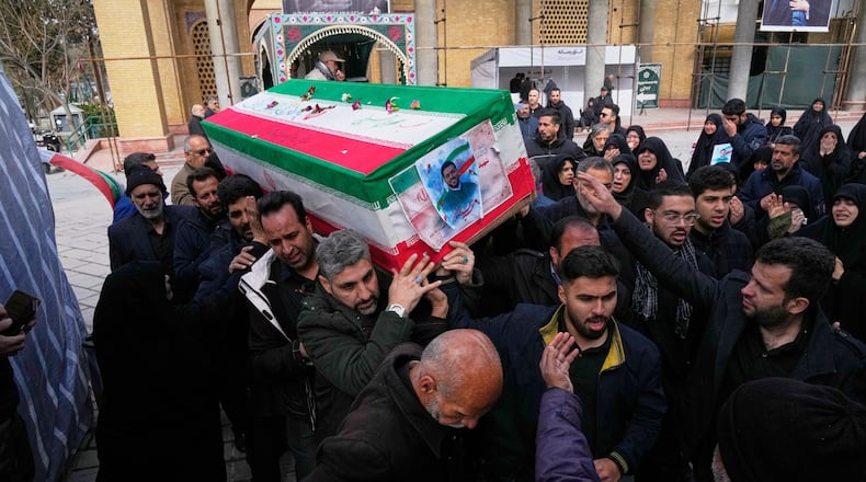The coffin of Mehdi Hosseini, a man killed in a U.S.-Israeli strike, is carried for burial at Behesht-e Zahra cemetery in Tehran, Iran, Monday, March 9, 2026. (AP Photo/Vahid Salemi)