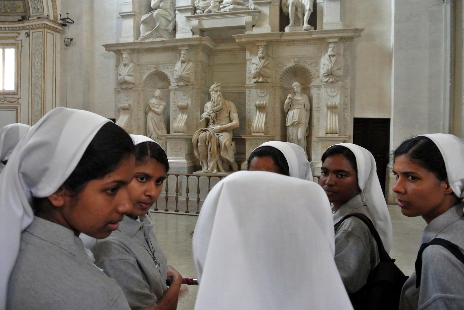 FILE - Nuns admire Michelangelo's Moses masterpiece, part of Pope Julius II's tomb, inside St. Peter's Basilica, in the Vatican, July 2, 2013. (AP Photo/Gregorio Borgia, File)
