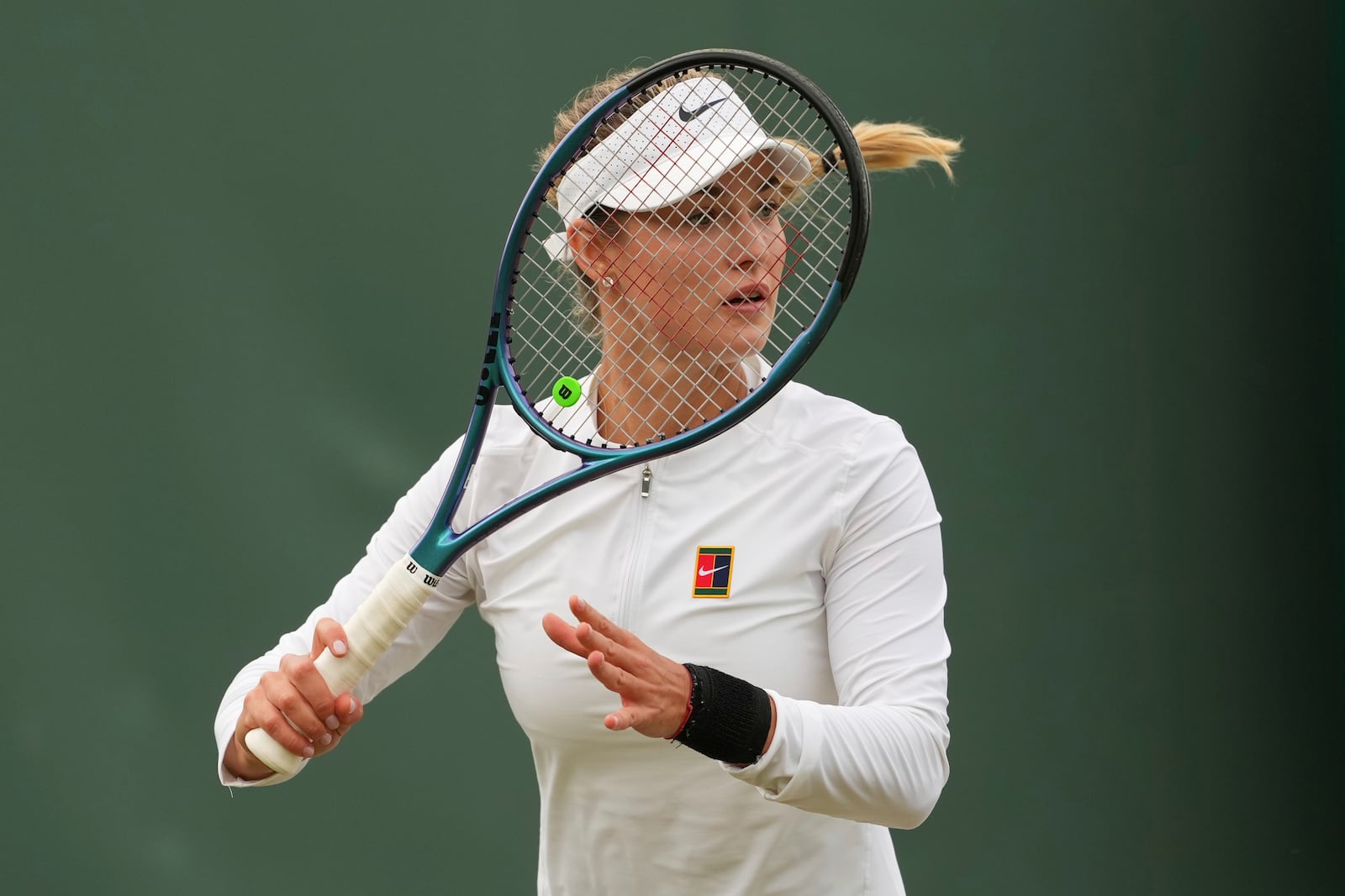 Anna Kalinskaya of Russia prepares to return to Clara Tauson of Denmark during their second round women's singles match at the Wimbledon Tennis Championships in London, Thursday, July 3, 2025. (AP Photo/Joanna Chan)