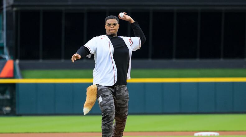 Cincinnati Bengals' Orlando Brown Jr. throws the ceremonial first pitch prior to a baseball game between the Texas Rangers and the Cincinnati Reds in Cincinnati, Tuesday, April 25, 2023. (AP Photo/Aaron Doster)
