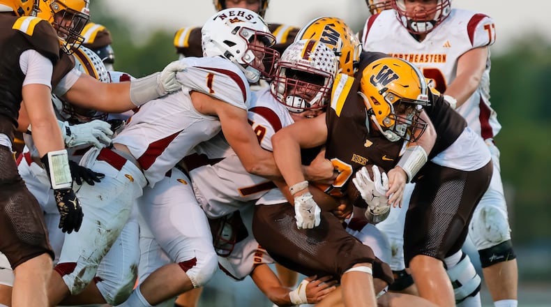 Northeastern High School senior Brock Gillam's nearly comes off as he tackles West Jefferson sophomore Wade Reeve during their game on Friday, Sept. 26 at Kile Field. West Jefferson won 42-36 in overtime. MICHAEL COOPER / STAFF