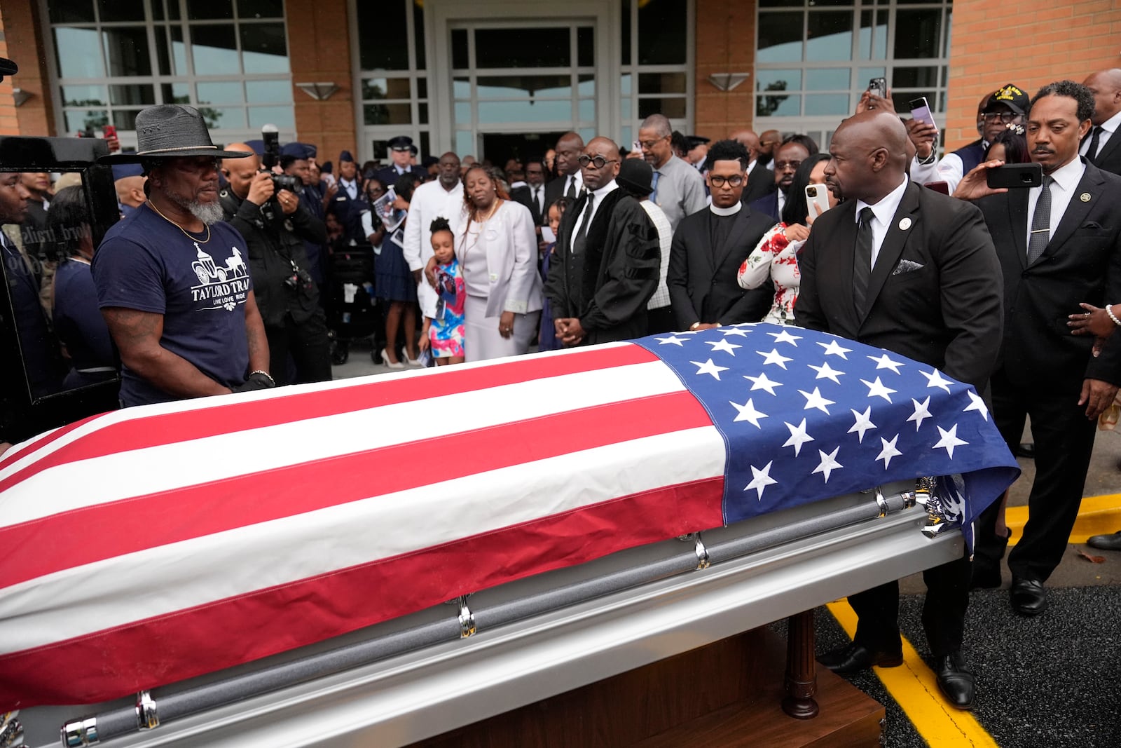 FILE - Friends and family of Roger Fortson watch as his casket leaves for the cemetery at New Birth Missionary Baptist Church on May 17, 2024, in Stonecrest, Ga. (AP Photo/Brynn Anderson, File)