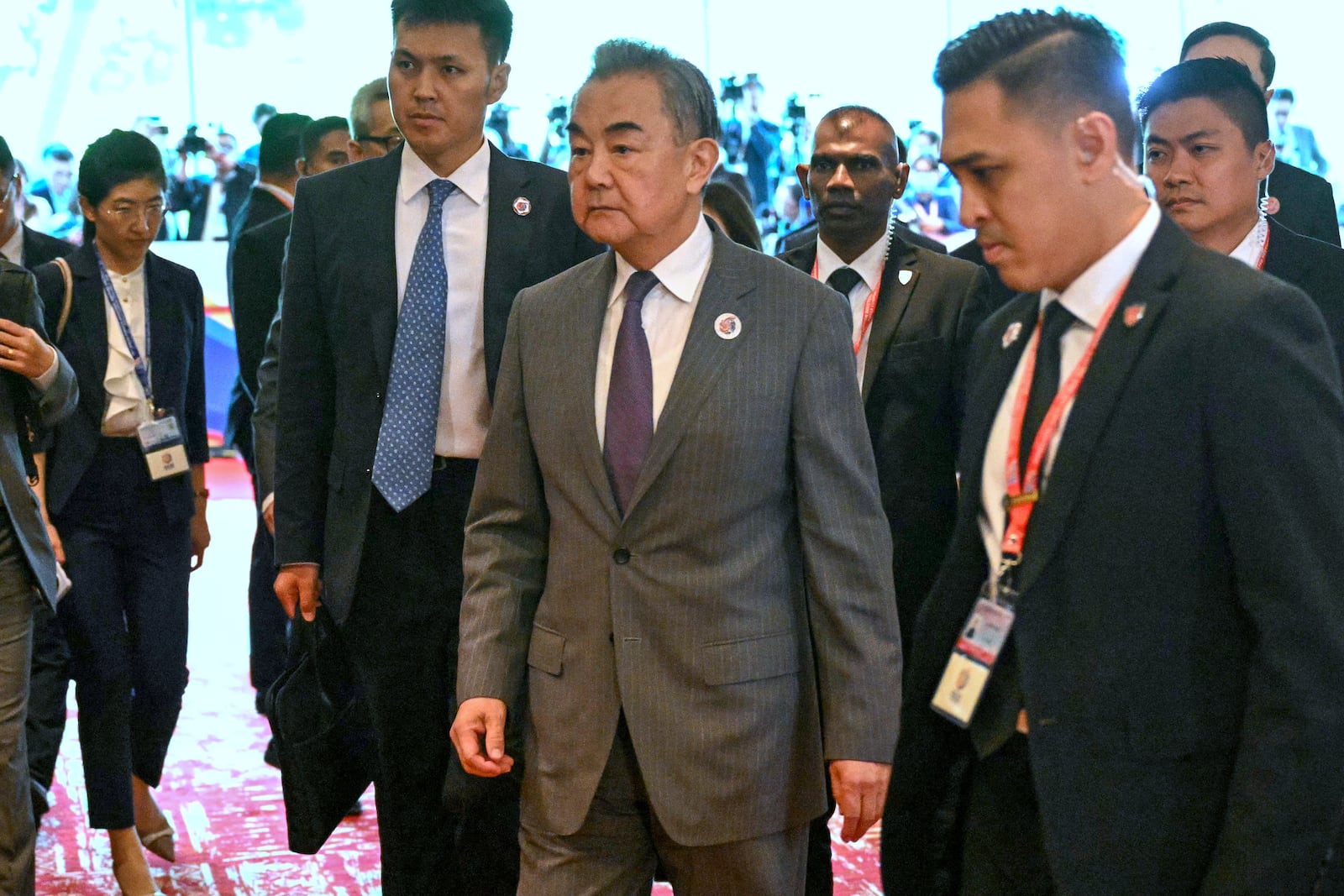China's Foreign Minister Wang Yi, center, walks on his way to a meeting with U.S. Secretary of State Marco Rubio, unseen, during the 58th ASEAN Foreign Ministers' meeting and related meetings at the Convention Centre in Kuala Lumpur Friday, July 11, 2025. (Mandel Ngan/Pool Photo via AP)