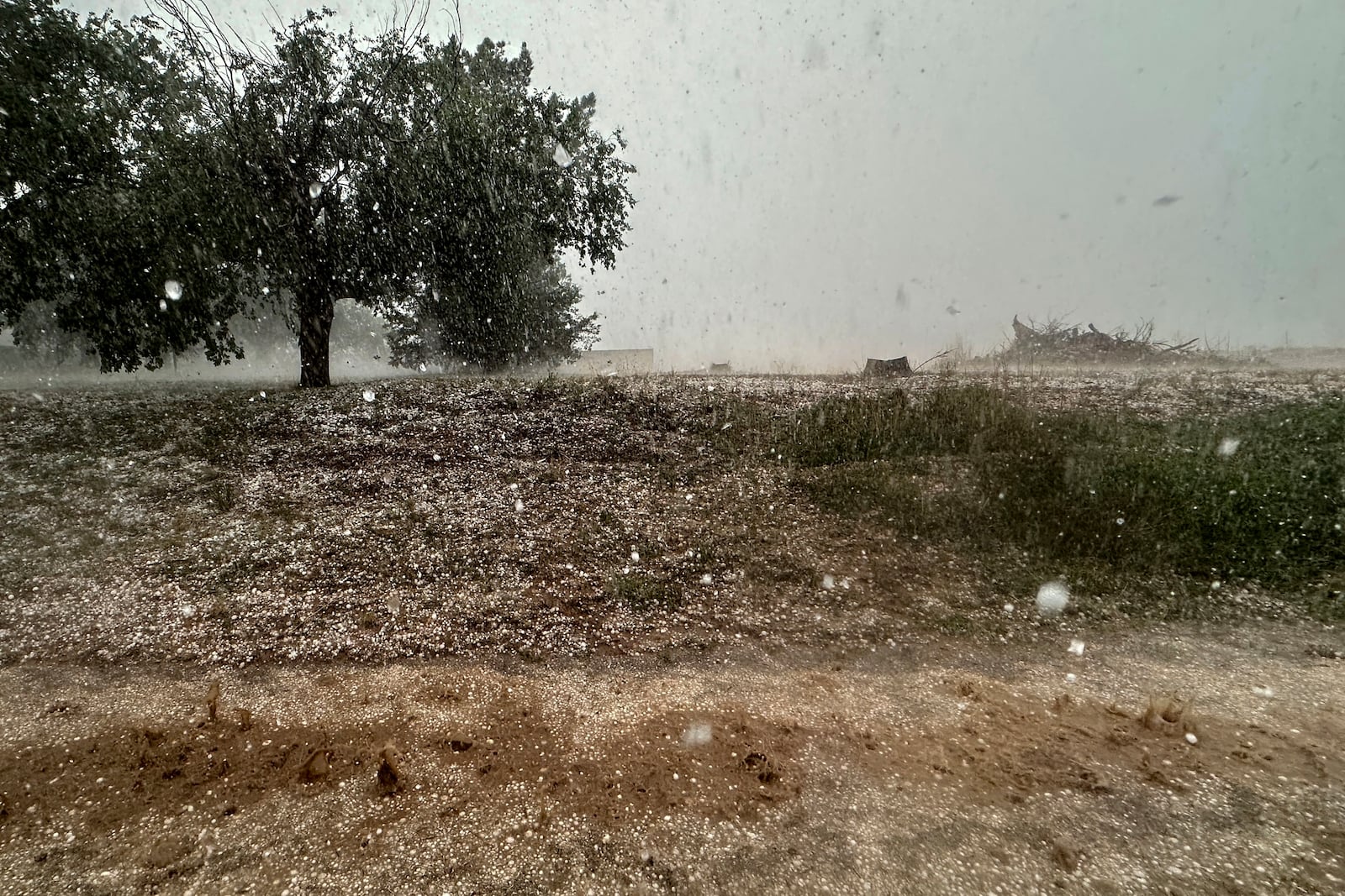 A hailstorm is visible from Northern Illinois University's Husky Hail Hunter vehicle during a Project ICECHIP operation Friday, June 6, 2025, in Levelland, Texas. (AP Photo/Carolyn Kaster)