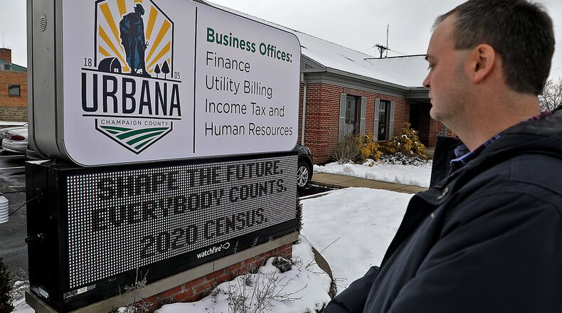 Doug Crabill, chairman of the Champaign County Census 2020 Complete Town Committee, looks over the LED sign in front of the Urbana Business Offices that reminds residents that everybody counts on the census. BILL LACKEY/STAFF