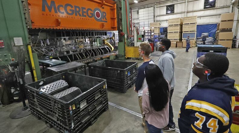 Springfield High School students look over a stamping press during a tour McGregor Metalworkings’ OSMI plant for Manufacturing Day Friday. Bill Lackey/Staff