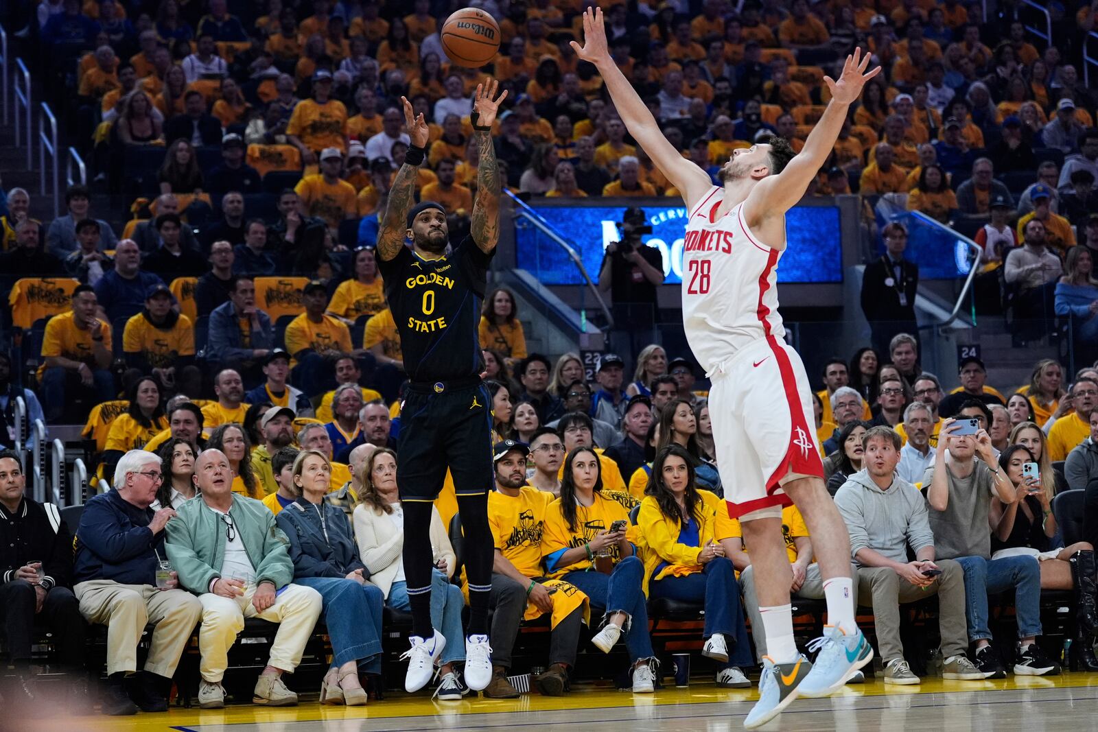 Golden State Warriors guard Gary Payton II (0) shoots a 3-point basket over Houston Rockets center Alperen Sengun (28) during the first half of Game 6 of an NBA basketball first-round playoff series Friday, May 2, 2025, in San Francisco. (AP Photo/Godofredo A. Vásquez)
