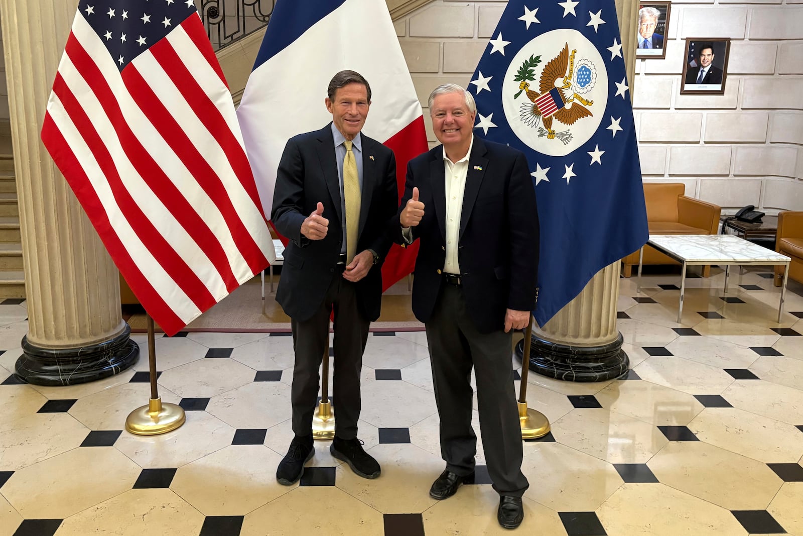 Sen. Richard Blumenthal, D-Conn., left, and Sen. Lindsey Graham, R-S.C thumb up during a news event at the US embassy to France, Sunday, June 1, 2025 in Paris. (AP Photo/Thomas Adamson)
