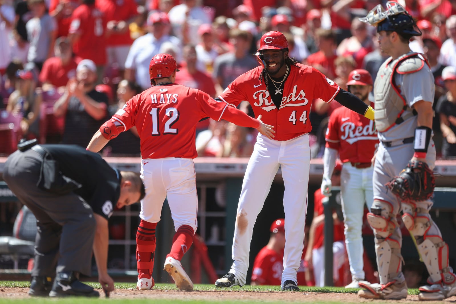 Cincinnati Reds' Austin Hays, left, celebrates with Elly De La Cruz after hitting a two-run home run during the fifth inning of a baseball game against the St. Louis Cardinals, Sunday, Aug. 31, 2025, in Cincinnati. (AP Photo/Abdoul Sow)