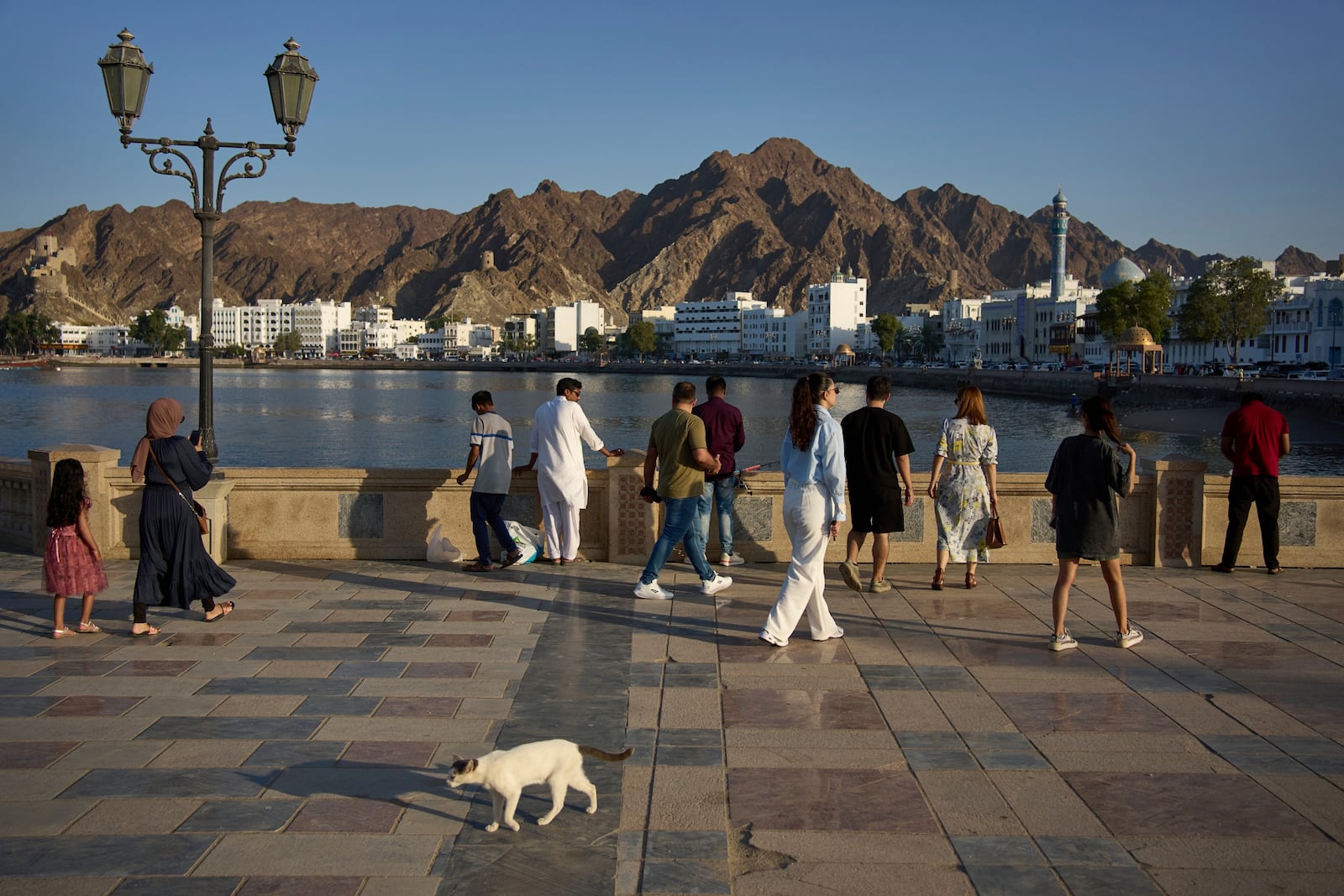 Visitors and locals gather at the Mutrah Corniche in Muscat, Oman, Friday, April 11, 2025. (AP Photo/ Fatima Shbair)