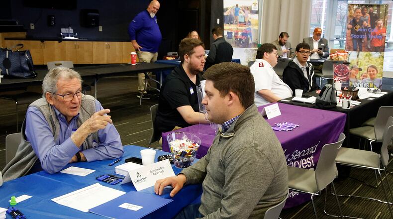 John Detrick, left, talks with James Gray, from Leadership Clark County, about the Springfield Rotary Club Thursday, April 11, 2024 during the Leadership Clark County Non-Profit Fair at the Hollenbeck Bayley Conference Center. BILL LACKEY/STAFF