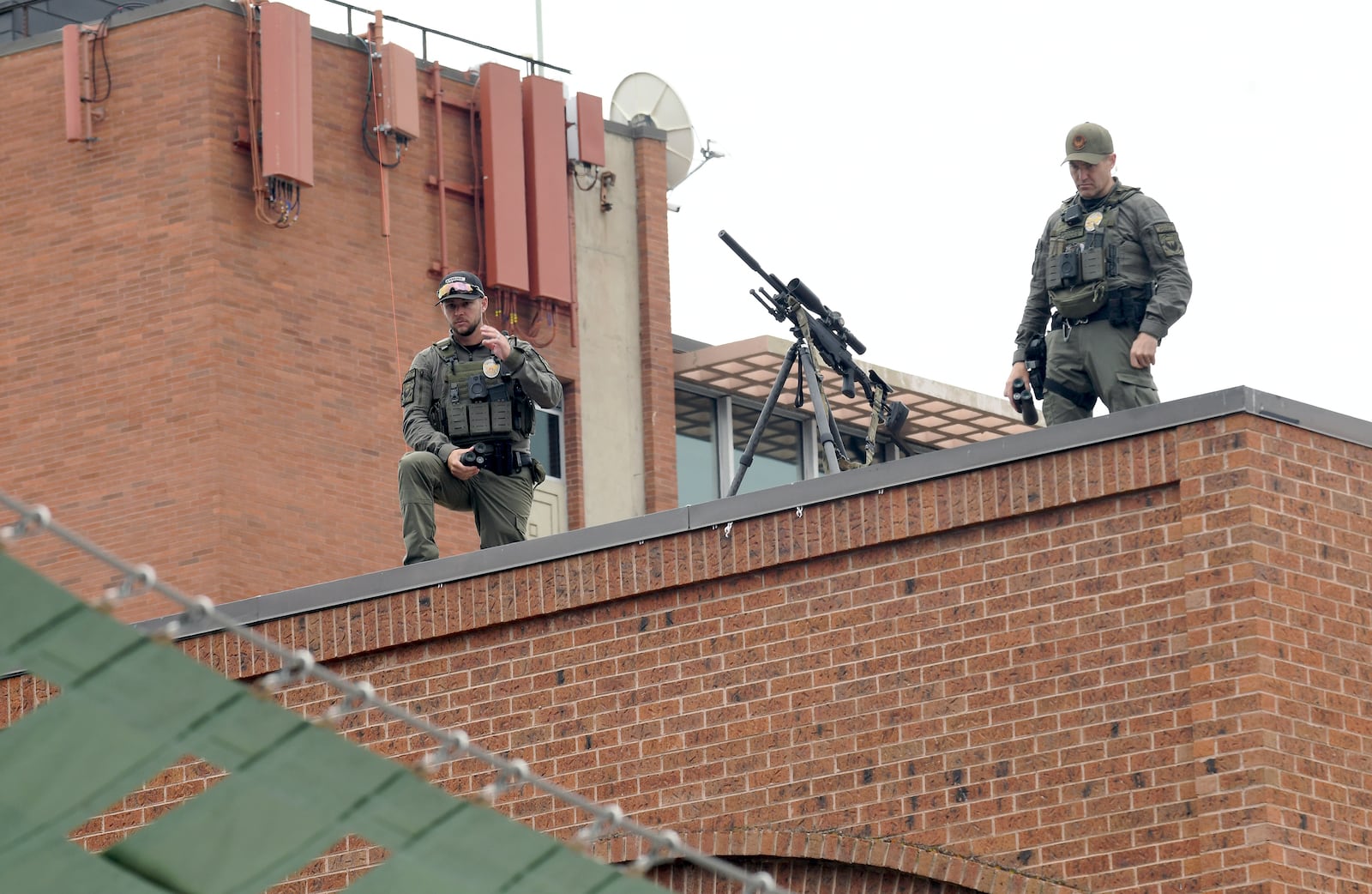 Law enforcement officers keep watch from a rooftop overlooking the Boulder Jewish Festival in Boulder, Colo., on Sunday, June 8, 2025. (AP Photo/Thomas Peipert)
