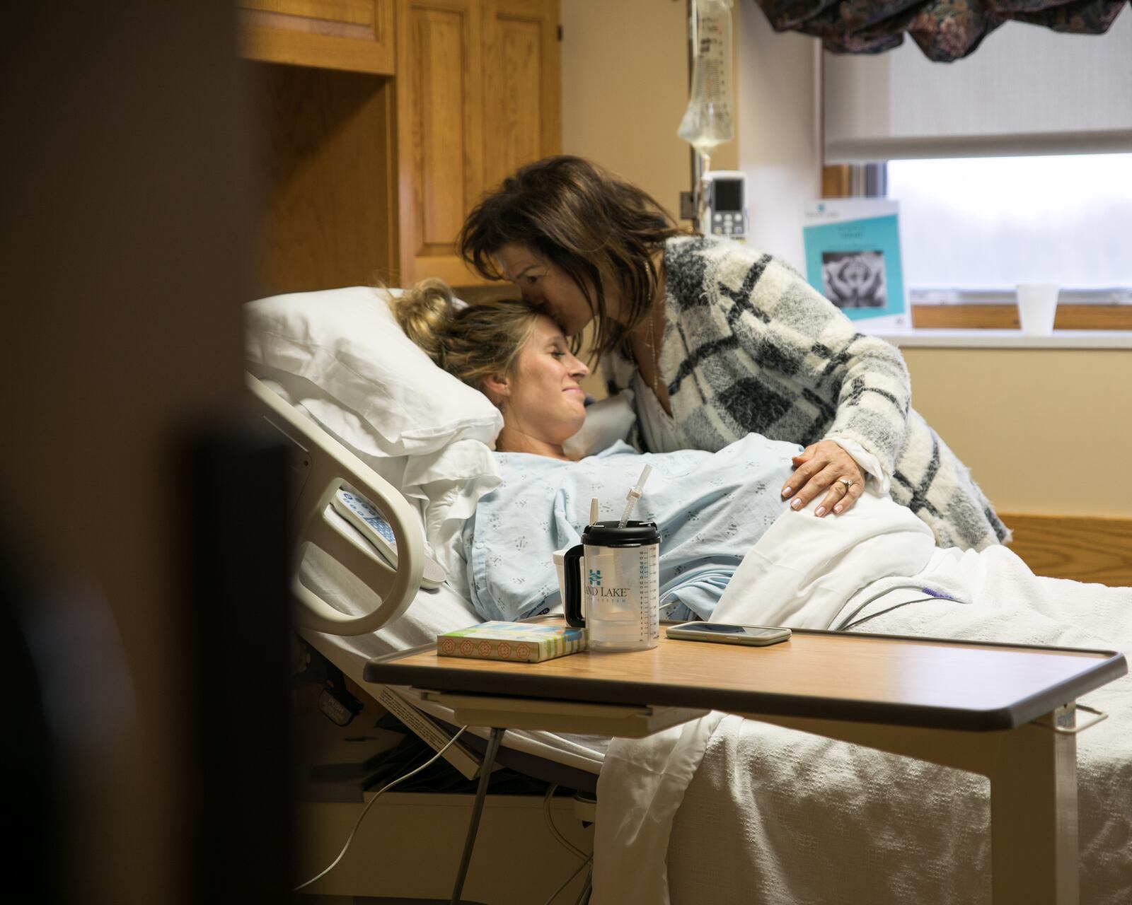 Emily Westerfield is shown during the final stages of labor with her second and third surrogate babies (twins) in December 2017. The babies' intended grandmother gives Westerfield a hug of gratitude for carrying the children.