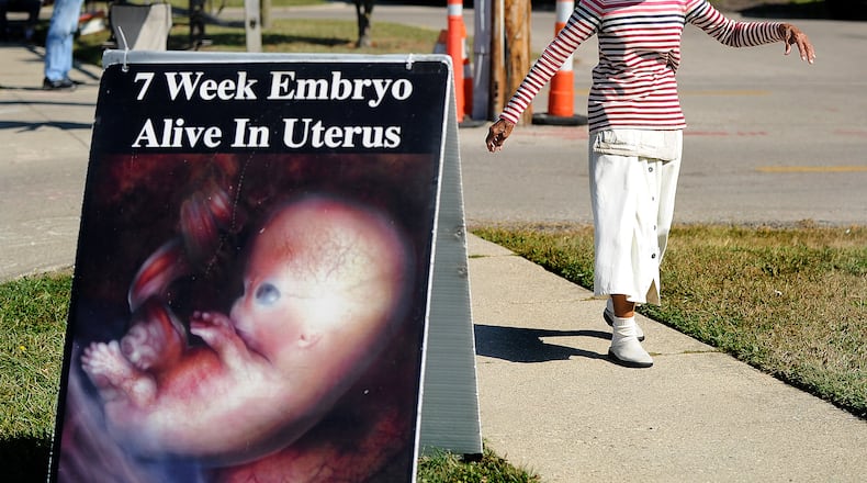Vivian Skovgard, sings dances outside the Women's Med Center of Dayton, Tuesday, Oct. 3, 2023. MARSHALL GORBY\STAFF