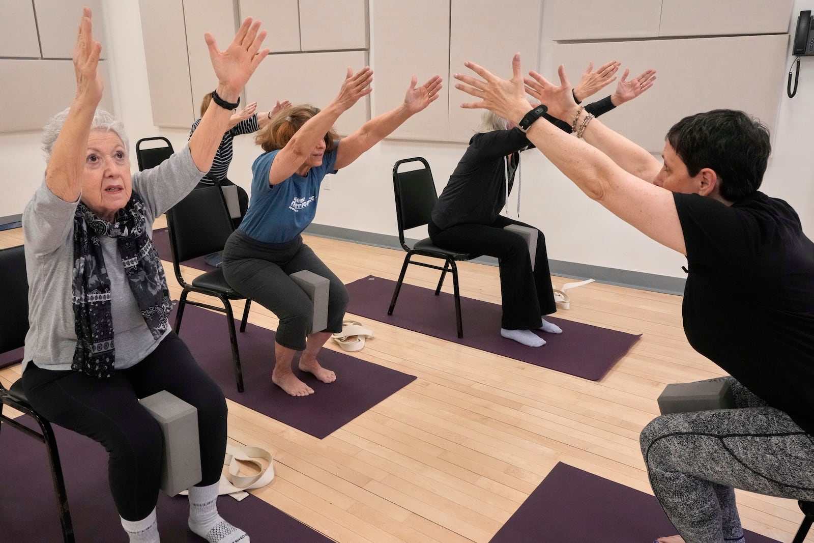 Whitney Chapman, right, conducts a chair yoga class at the Marlene Meyerson JCC Manhattan, in New York, March 28, 2025. (AP Photo/Richard Drew)