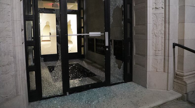 One of the broken windows at the Springfield City Hall on Monday that was vandalized the day before, on May 31. BILL LACKEY/STAFF