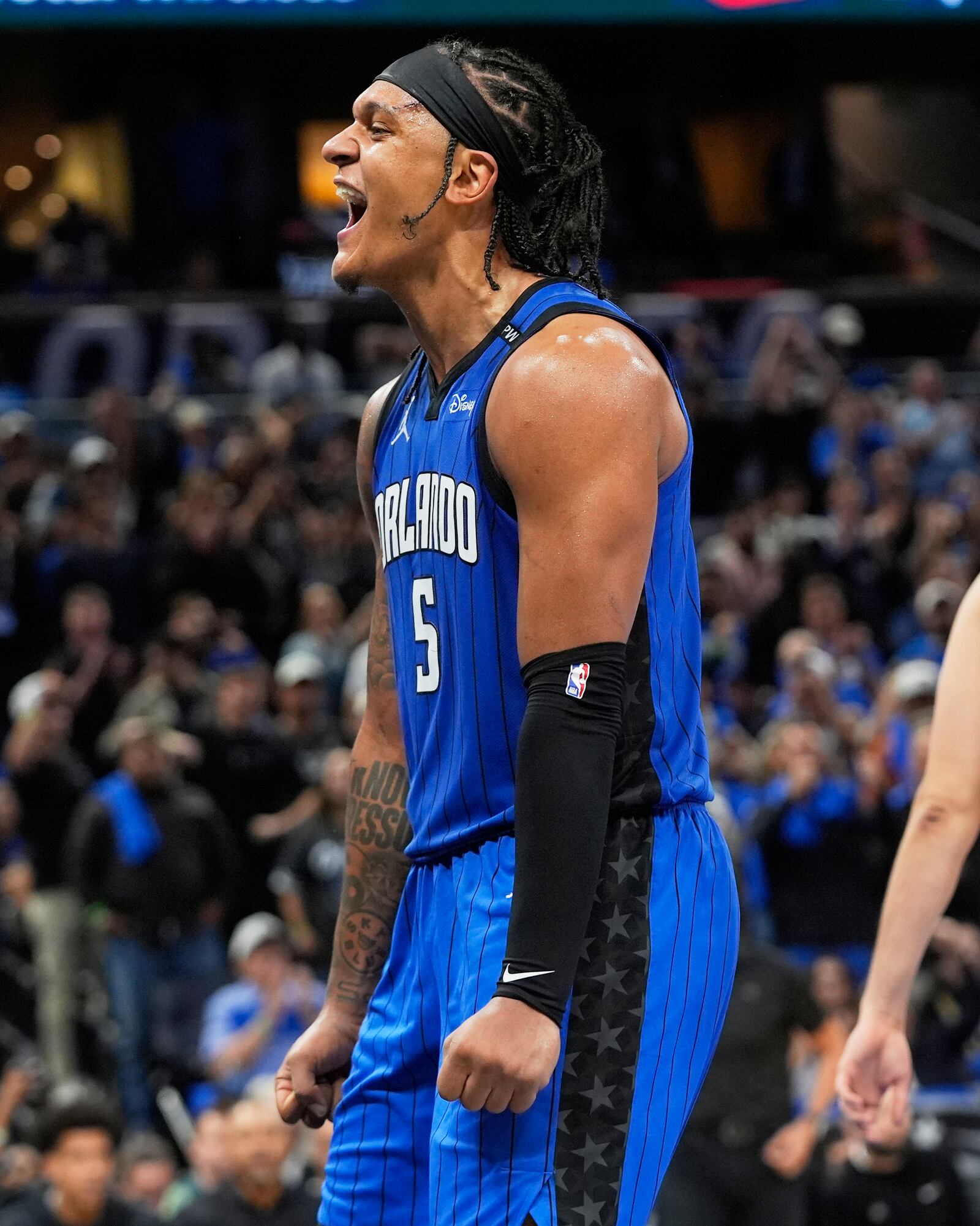Orlando Magic forward Paolo Banchero (5) celebrates after teammate forward Franz Wagner made a shot against the Atlanta Hawks during the second half of an NBA play-in tournament basketball game, Tuesday, April 15, 2025, in Orlando, Fla. (AP Photo/John Raoux)