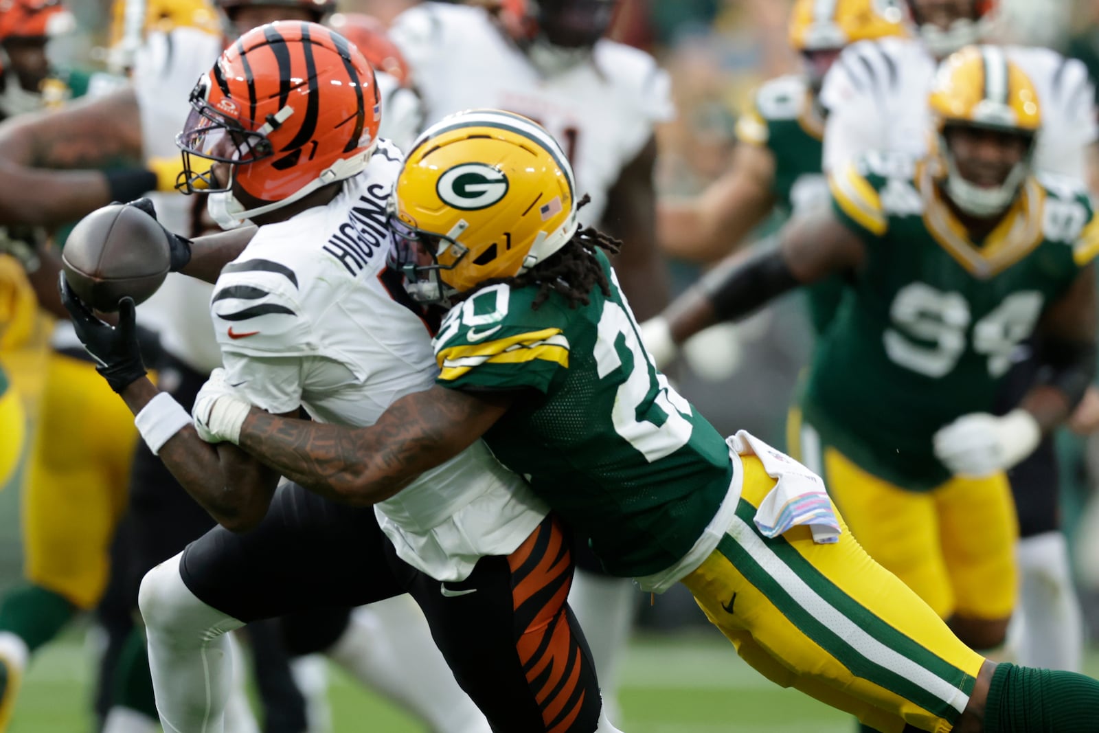 Cincinnati Bengals wide receiver Tee Higgins (5) makes the catch agaimnst Green Bay Packers safety Javon Bullard (20)in the second half of an NFL football game, Sunday, Oct. 12, 2025, in Green Bay, Wis. (AP Photo/Matt Ludtke)