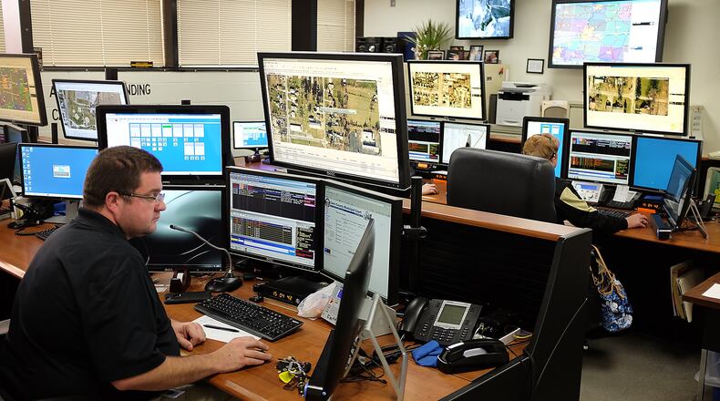 Clark County dispatcher Brad Carey, left, working in the dispatch center in the Clark County Sheriff’s Office. The sheriff’s budget for this year is about $15 million. Bill Lackey/Staff