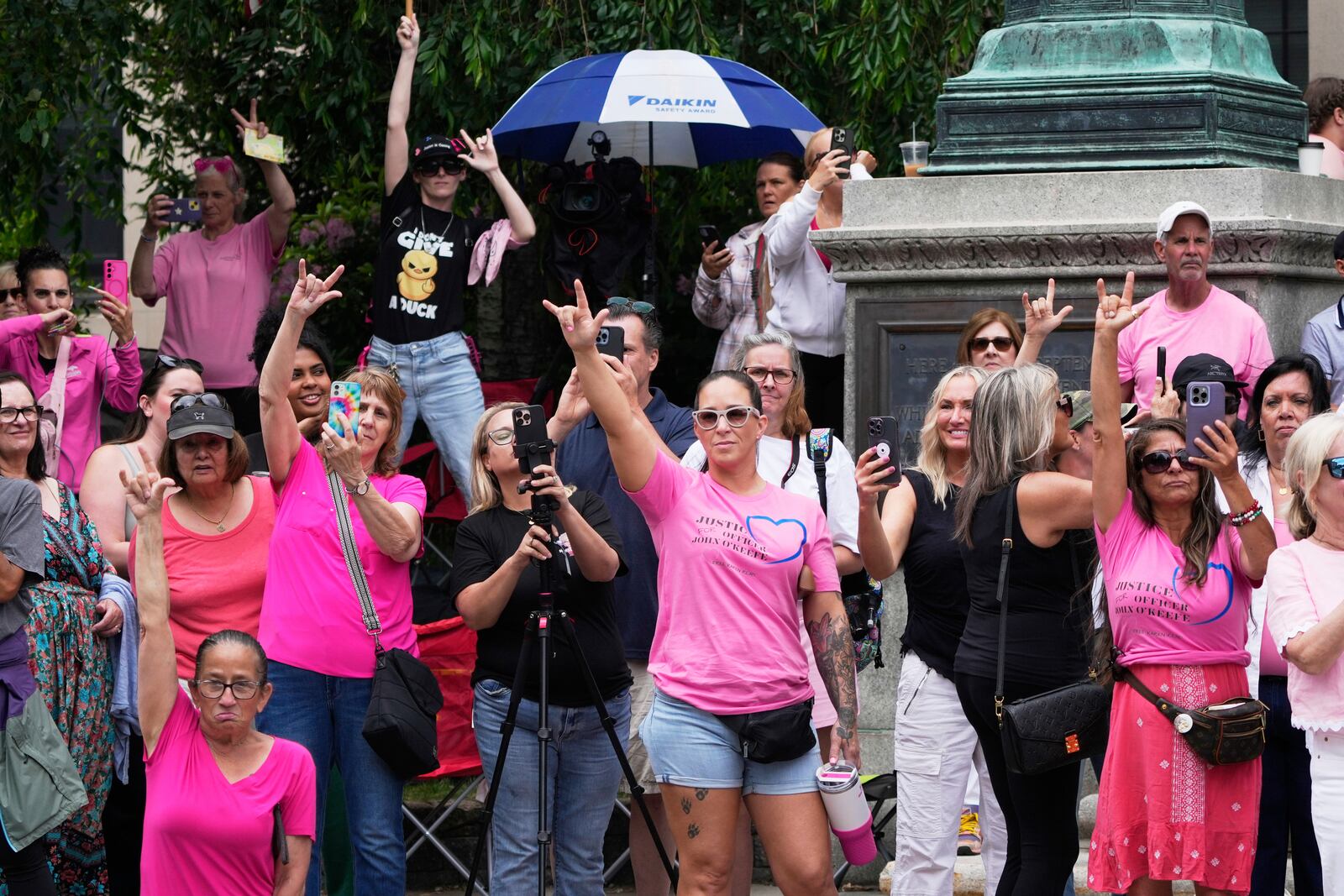 Supporters of Karen Read gesture as Read departs Norfolk Superior Court during jury deliberations at her trial, Tuesday, June 17, 2025, in Dedham, Mass. (AP Photo/Charles Krupa)