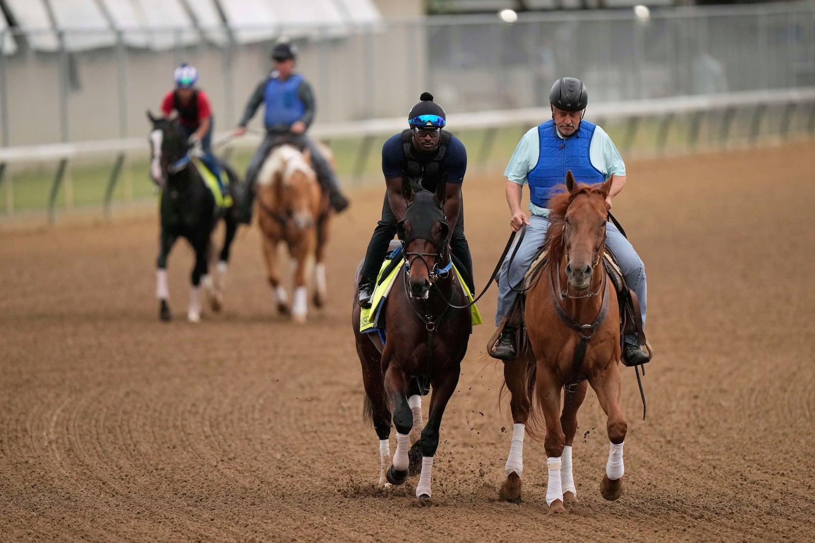 Kentucky Derby entrant Publisher is led by trainer Steve Asmussen during a workout at Churchill Downs Wednesday, April 30, 2025, in Louisville, Ky. (AP Photo/Charlie Riedel)