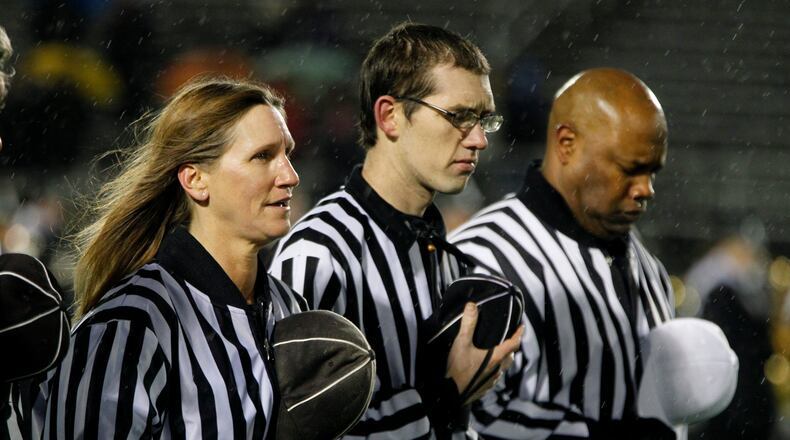 Teri Hobbs (left), Greg White and Perry Gullette before a Greenville at Sidney football game. LISA POWELL / STAFF