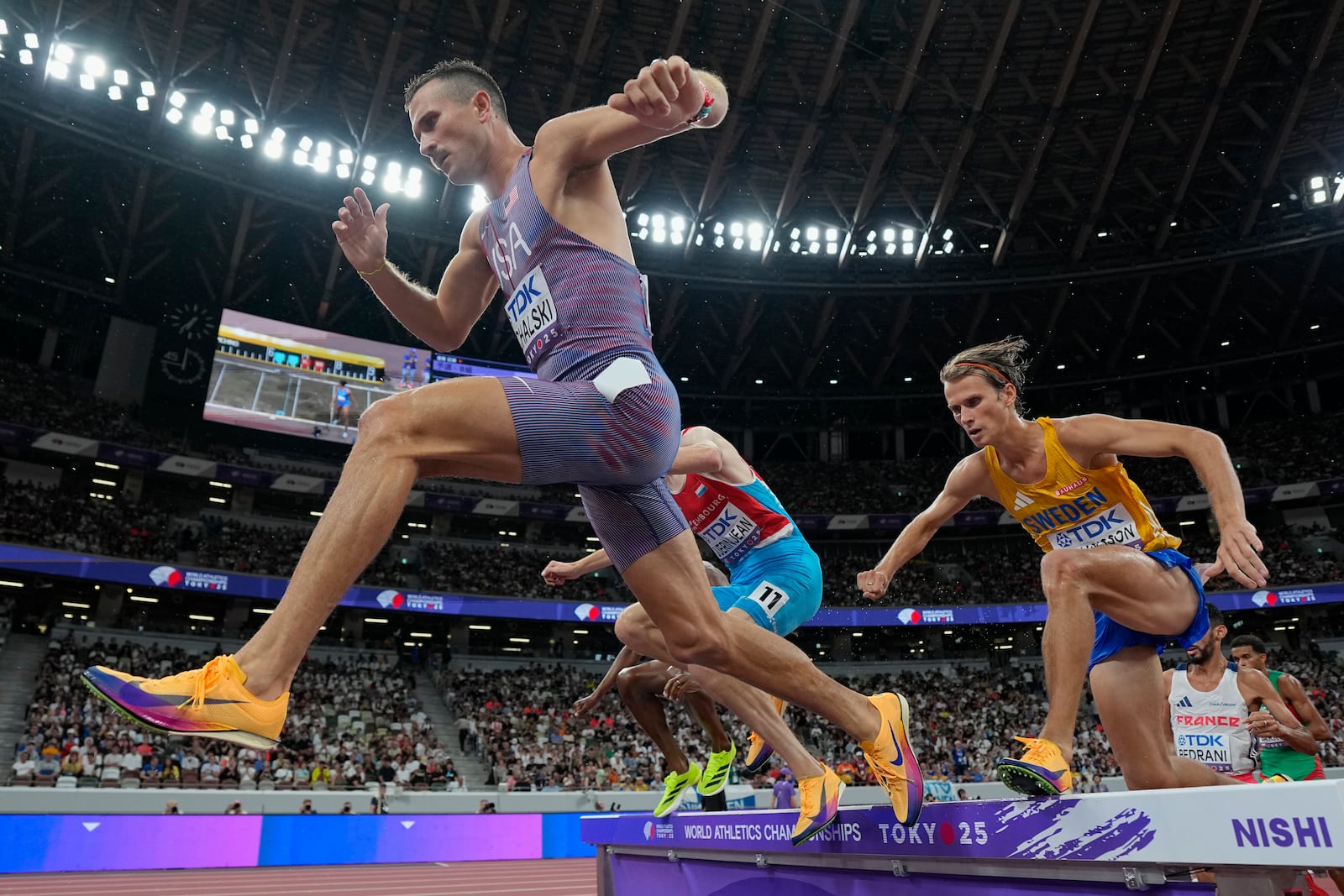 United States' Daniel Michalski, left, and Sweden's Vidar Johansson, right, compete in a men's 3,000 meters steeplechase heat at the World Athletics Championships in Tokyo, Saturday, Sept. 13, 2025. (AP Photo/Ashley Landis)