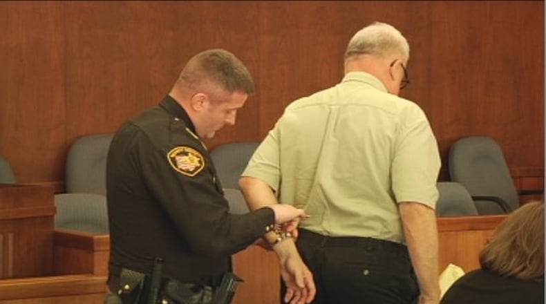 A Champaign County sheriff’s deputy handcuffs Jeffrey McClain in court on Wednesday morning. McClain was sentenced to a total of 13 years in prison for sex crimes involving young boys. JENNA LAWSON/STAFF