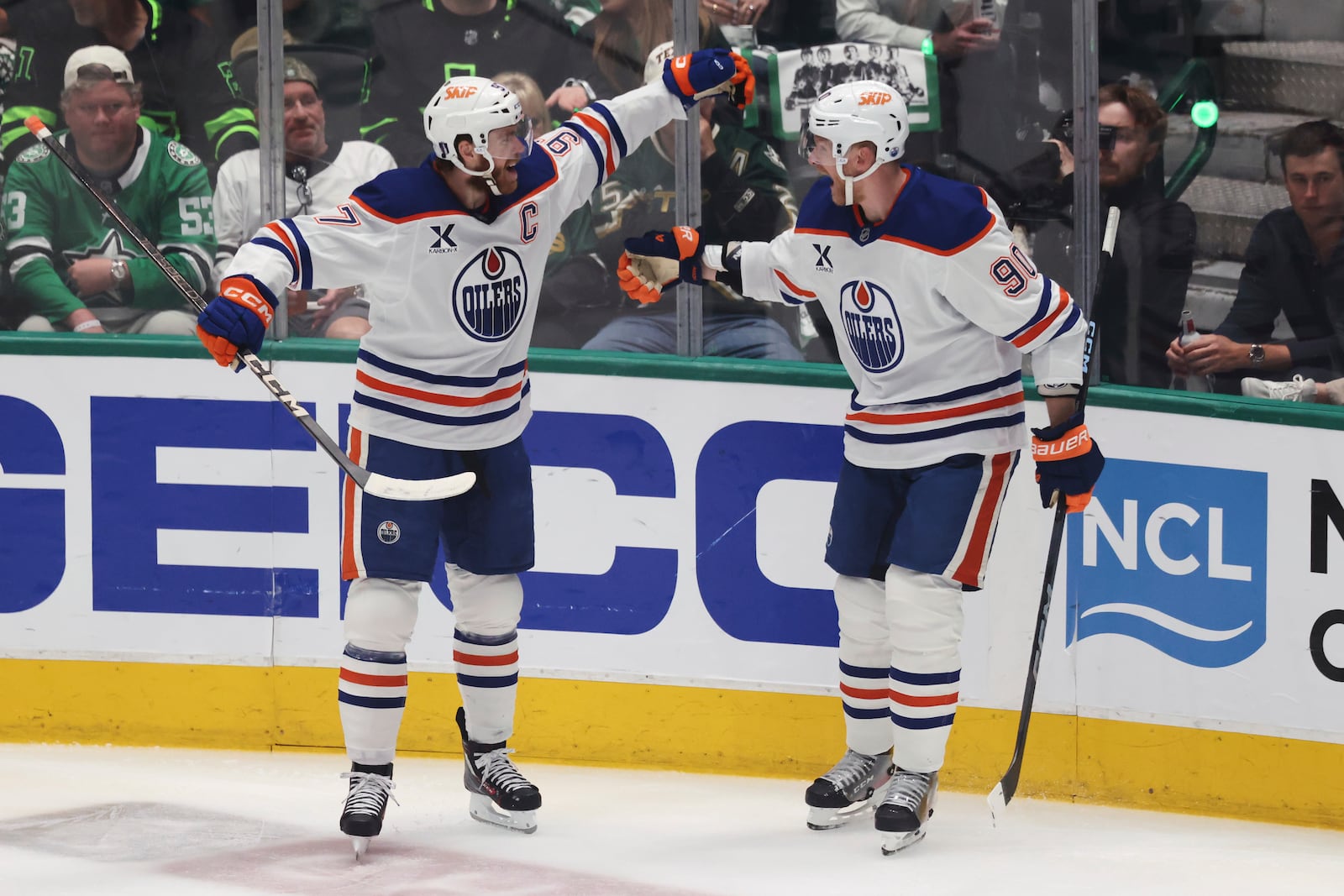 Edmonton Oilers right wing Corey Perry, right, celebrates with center Connor McDavid after scoring during the first period of Game 5 of the Western Conference finals in the NHL hockey Stanley Cup playoffs, Thursday, May 29, 2025, in Dallas. (AP Photo/Gareth Patterson)