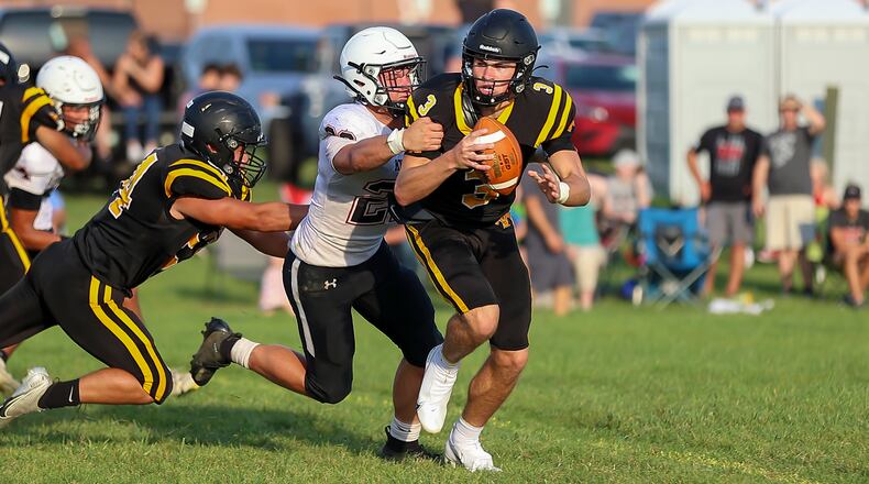 Greenon1: Greenon's Trevor Stewart brings down Shawnee quarterback RJ Griffin during their scrimmage game on Friday, Aug. 13 in Springfield. CONTRIBUTED PHOTO BY MICHAEL COOPER